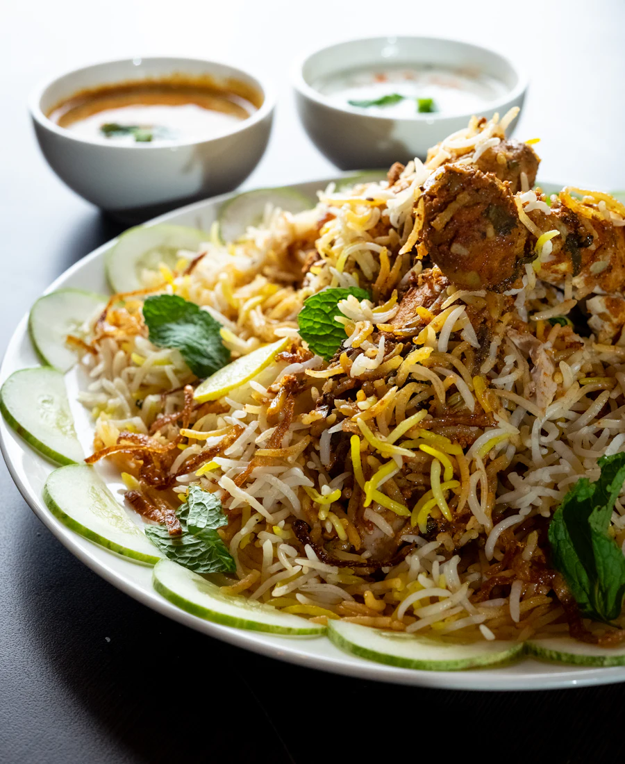 Fragrant dum biryani with tender meat, saffron rice and fresh lime