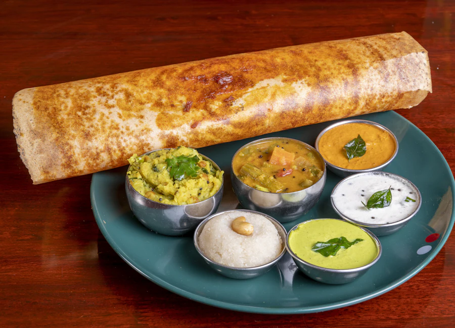 A crisp masala dosa served with sambar and coconut chutneys